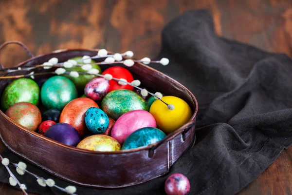 Easter colorful painted eggs and willow on dark rustic backgroun — Stock Photo, Image