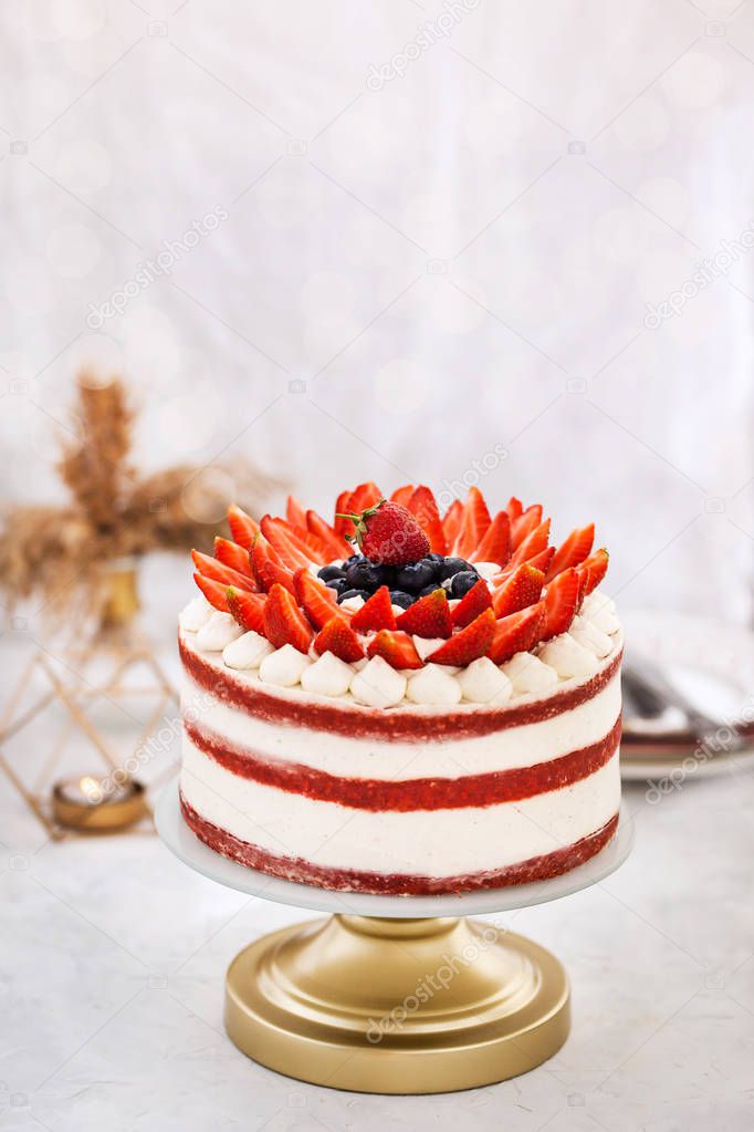 Delicious homemade naked red velvet cake decorated with cream an