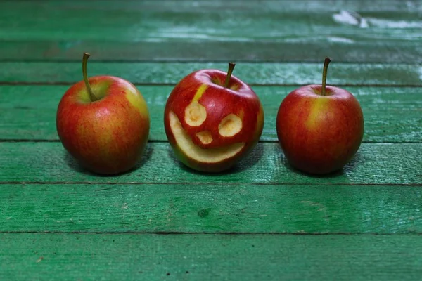 two apples and a apple with a face