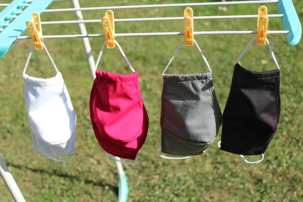 many face masks on a clothesline