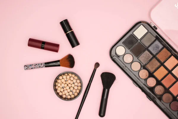 Make up and cosmetics products on pink background