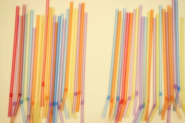 Colorful plastic tube on yellow background