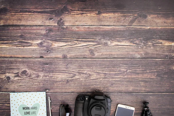 Travel kit and cameras on wooden background