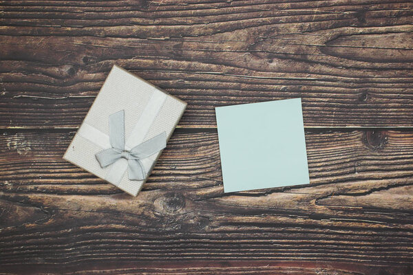 Silver present for happy birthday on wooden table 