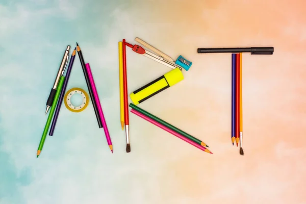 Art title made of art tools on the colorful background