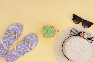 Sarı arka planda yaz ve plaj aksesuarları 