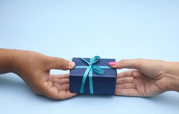 Woman give gift to man