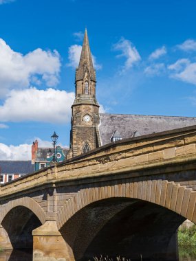 Section of the Morpeth Telford Bridge and spire of St Georges United Reformed Church at Morpeth, Northumberland, UK clipart