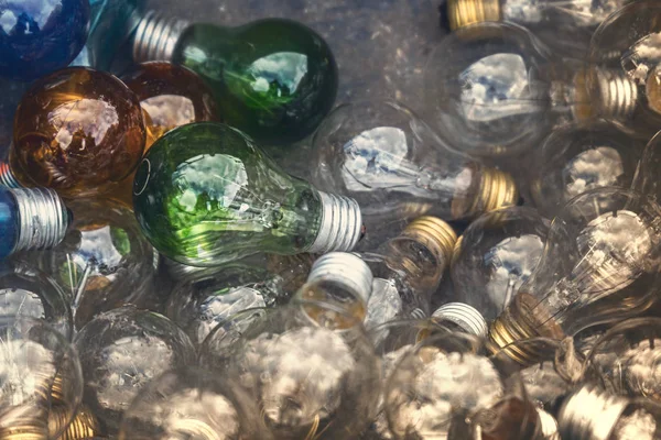 Colored light bulbs laying on the ground — Stock Photo, Image