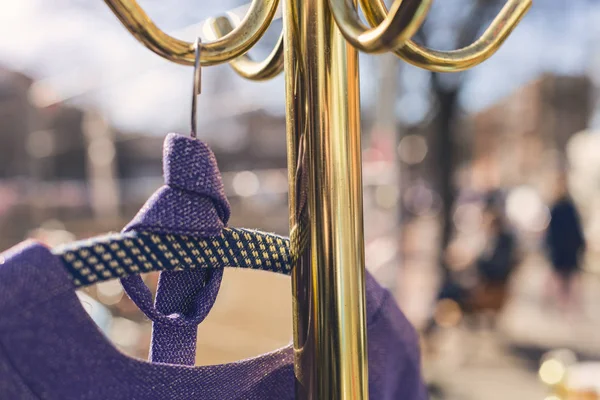 Flea market, purple dress hanging on a golden clothes rack — Stock Photo, Image