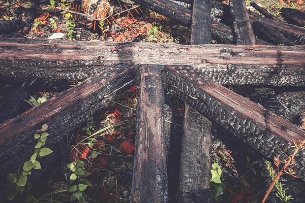 Burned roof beams laying on the ground — Stock Photo, Image