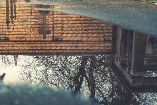 Reflection of a cross in a puddle — Stock Photo, Image
