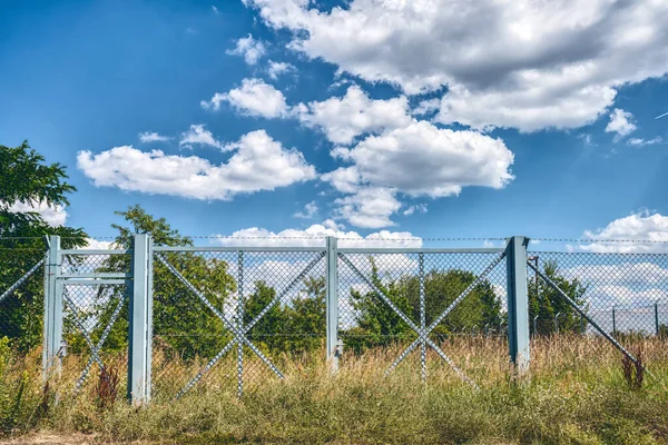 Голубые Металлические Ворота Колючей Проволокой Ландшафте — стоковое фото