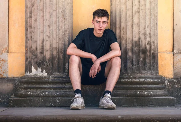 Portret Van Een Jongeman Zittend Tussen Twee Oude Pilaren Stockfoto