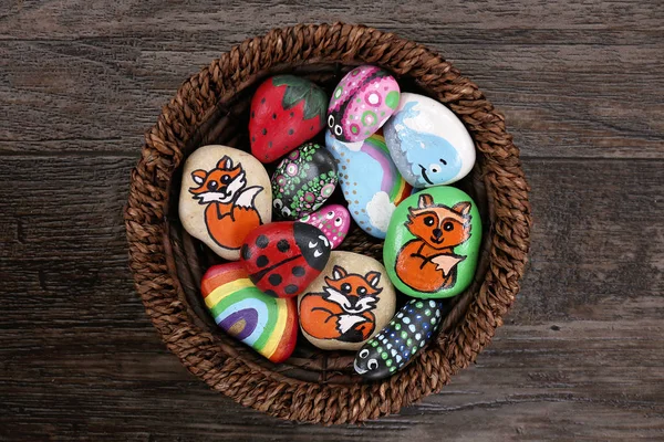 Collection Fun Handpainted Colorful Cartoon Rocks Together Wicker Basket Wooden — Stock Photo, Image