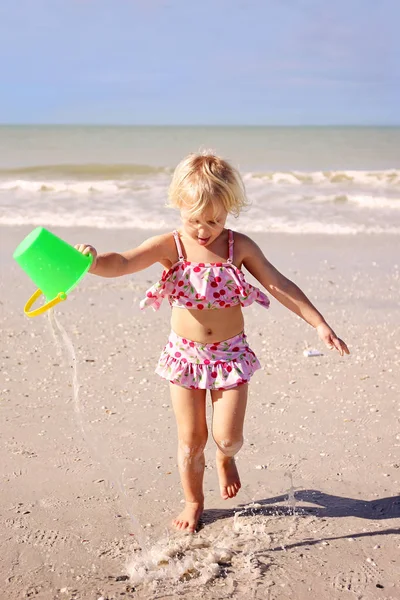 Little Kid Running on The Beach by The Ocean with a Bucket of Wa — Stock Photo, Image