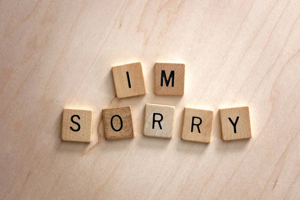 Words I'm Sorry Spelled out in Wooden Letter Blocks on Wood Back — Stock Photo, Image