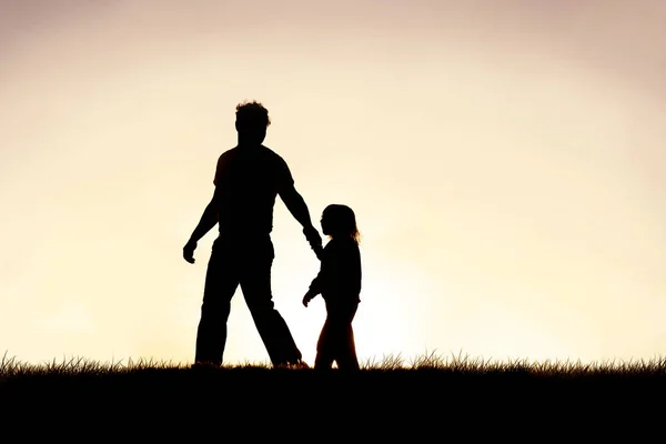 Silhouette of Christian Father Guiding his Young Child by the Ha — Stock Photo, Image