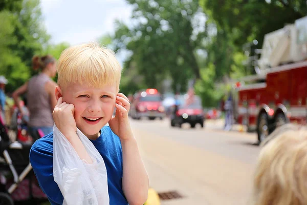 Cute Boy Child at Parade Plugging his Ears from the Loud Fire Tr — Stock Photo, Image