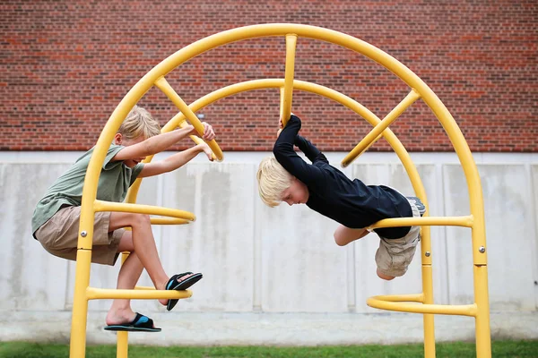 Little Kids Climbing on the Jungle Gym Bars at Playground at School — Stock fotografie