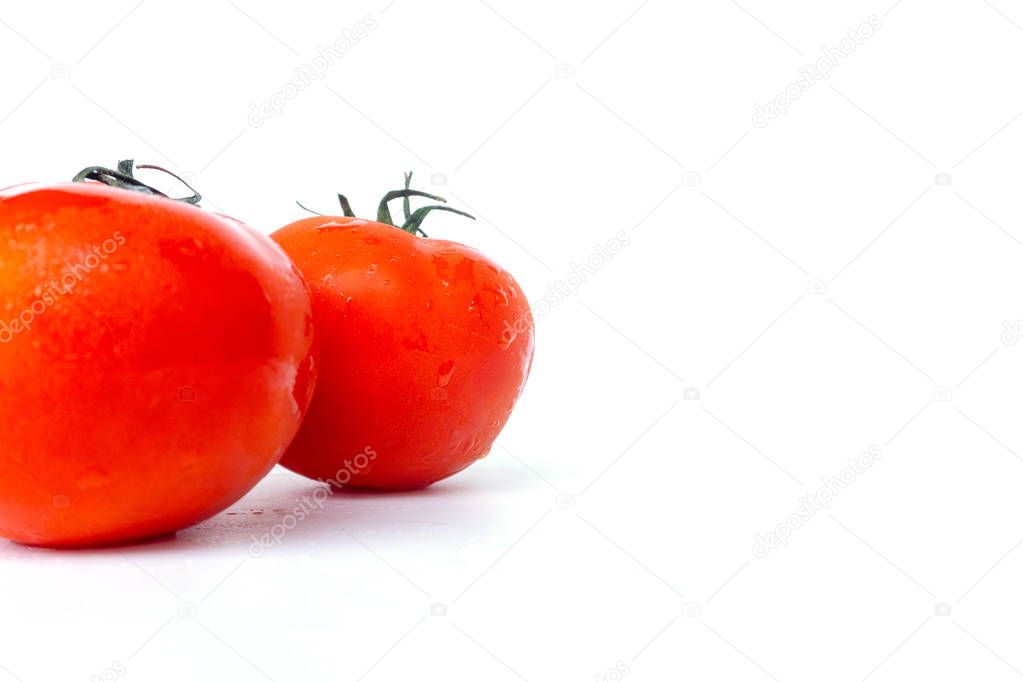 Close up red tomatoes isolated on white background.Tomato with droplets of water.Fresh tomatoes ready to cook.Tomatoes are vegetables that contain vitamin C and A. And also have anti-oxidants such as lycopene Beta-carotene and phosphorus as well. 
