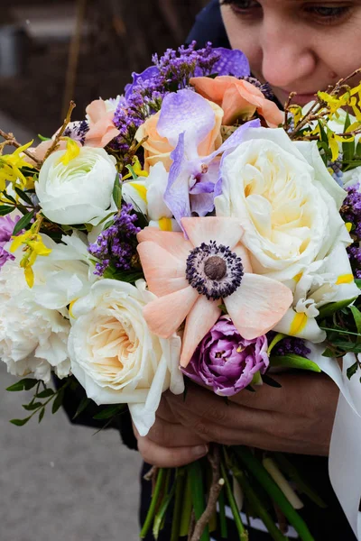 bouquet of flowers lilac, rose, Narcissus, hyacinth, Ranunculus, Tulip, Bush rose, chrysanthemum, eucalyptus, anemone, peony in a florist shop