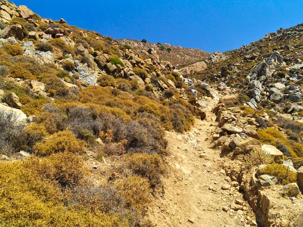 Sert manzara, toprak yolu çalı ve kayalar, sıcak yaz günü, Patmos adası, Yunanistan.
