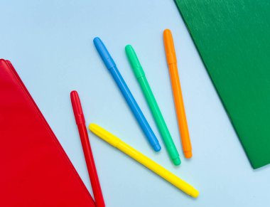 Açık mavi arka plan üzerinde kırmızı ve yeşil dizüstü bilgisayarlar ve renkli işaretler.