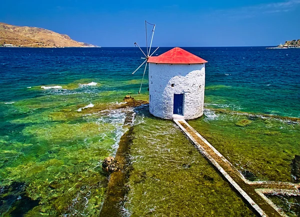 Traditional windmill in the sea. Landmark of Leros island, Greece, located at Agia (Saint) Marina coast.