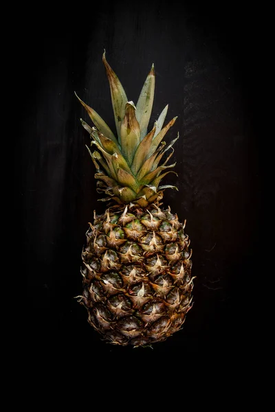 Pineapple isolated on black wood background, ananas tropical fruit — Stock Photo, Image