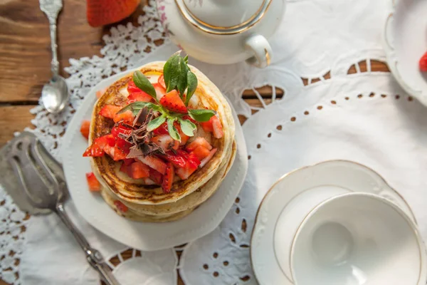 Strawberry chocolate pancakes on a vintage table — Stock Photo, Image