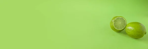 Perfect Fresh Green lime fruit Isolated on green Background Full Depth of Field Banner