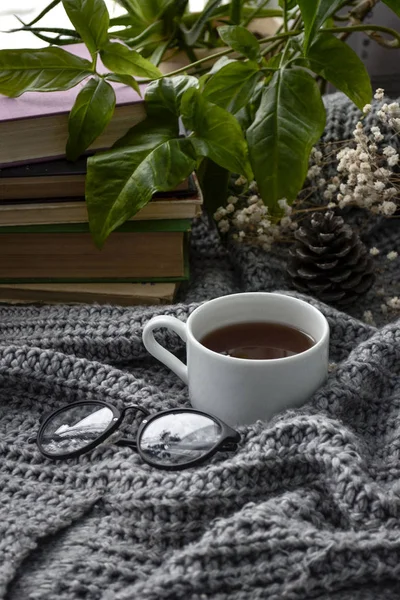 coffee and books on a cozy blanket with flowers