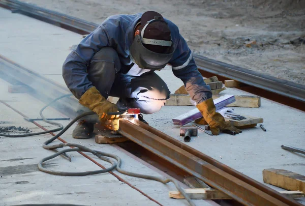 Worker welds a tram rail joint