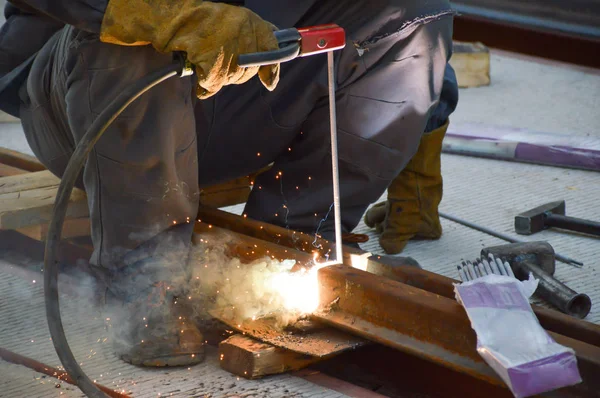 Worker welds a tram rail joint