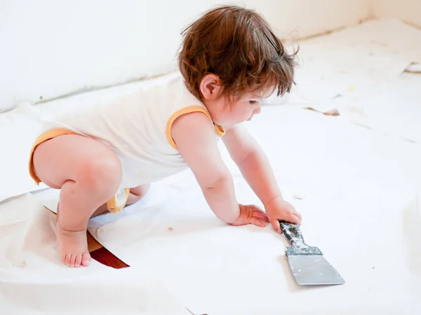 Reparação e bebê. Menino com instrumentos para renovação apartamento isolado em um fundo branco. Papel de parede, acessórios de colagem, ferramentas de pintura. Reparação de casas. Conceito de paternidade infantil. reparação no — Fotografia de Stock