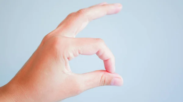 Okay hand on a gray background. Top view, flat lay. space for your task or message. — Stock Photo, Image