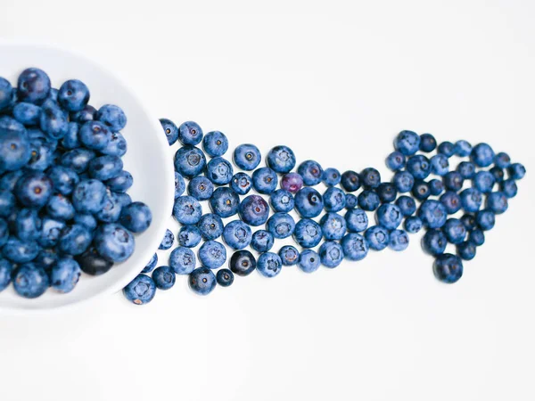 Blueberry Arrow. composition of fresh blueberry onions on a white background. pointer to vitamins, berries. Top view, flat lay