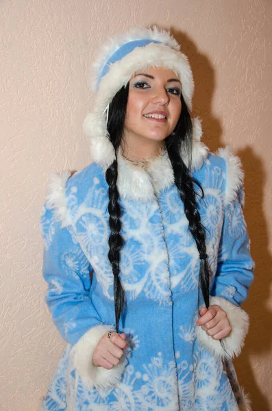 Young Snow Maiden. Sexy woman dressed in the traditional Russian New Year\'s costume Snow Maiden, a girl in a blue New Year\'s suit.