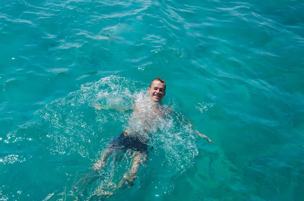 O tipo mergulhou no mar com um sorriso. Mar refrescante — Fotografia de Stock