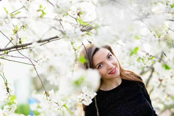girl with flowers. Gorgeous model in the spring garden. girl near the tree in spring. the concept of spring. young garden. Blooming tree