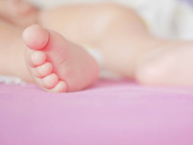 Küçük bebek ayakları. Minik bebek ayakları kadar tatlı bir şey yoktur. Küçük erkek bebek yatakta. Kapatın. Kopyalamak için boşluk.