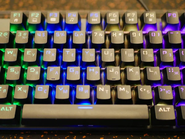 multi-colored keyboard. mechanical keys. Multi-colored professional gaming mechanical rgb keyboard on the table background