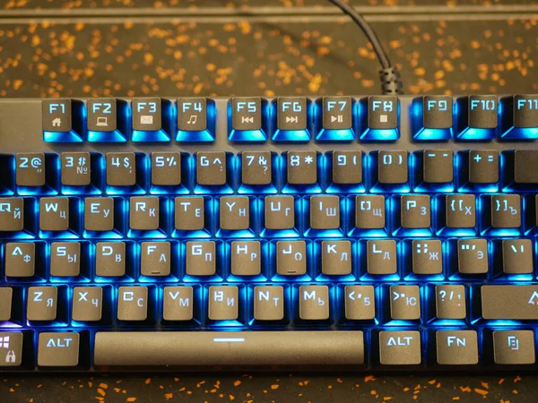 multi-colored keyboard. mechanical keys. Multi-colored professional gaming mechanical rgb keyboard on the table background