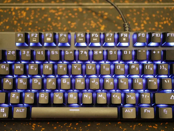 multi-colored keyboard. mechanical keys. Multi-colored professional gaming mechanical rgb keyboard on the table background