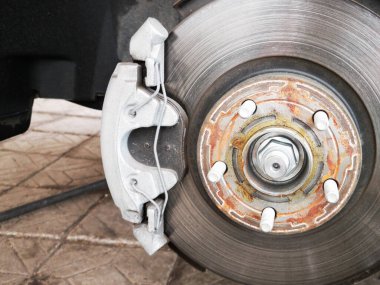 Yeni lastik değiştirme işlemi sırasında arabanın disk freni. Pervane ve kalibre görünüyor. Yaklaş..
