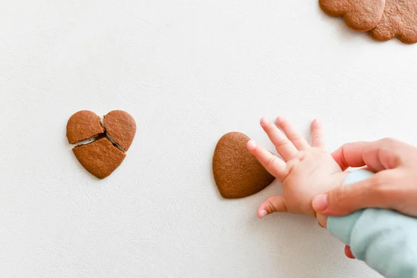 baby hands, fragile heart, health care, love and family concept, world heart day