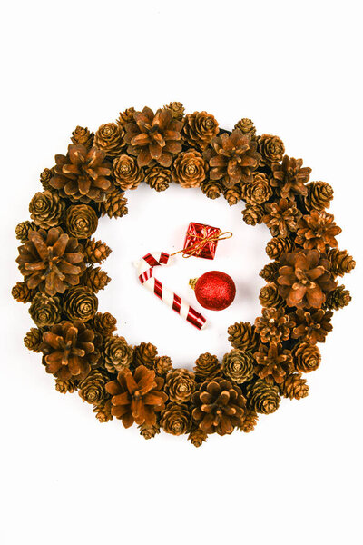 A wreath of cones on a white background. Handwork. preparing for christmas. place for writing. View from above