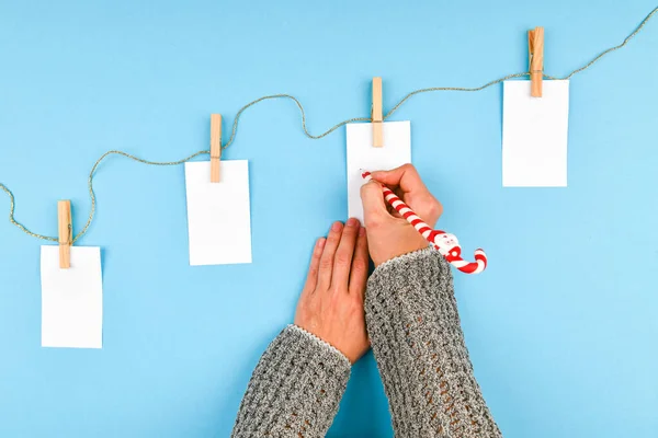 Girl's hand writes New Year's wishes. Girl Writes Pen On A Piece Of Paper Christmas Wishes