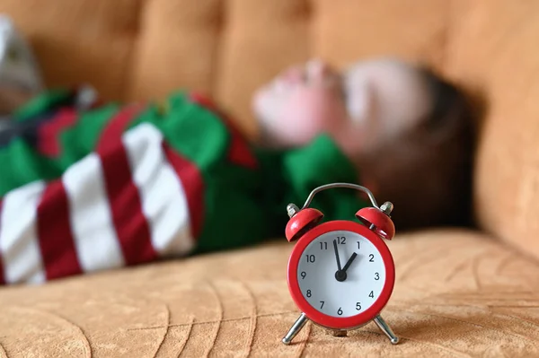 Babys daytime sleep. Lunch baby sleep. the red clock shows the babys sleep time